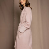 A woman wears a pure 100% cashmere dressing gown or robe in dusty pink