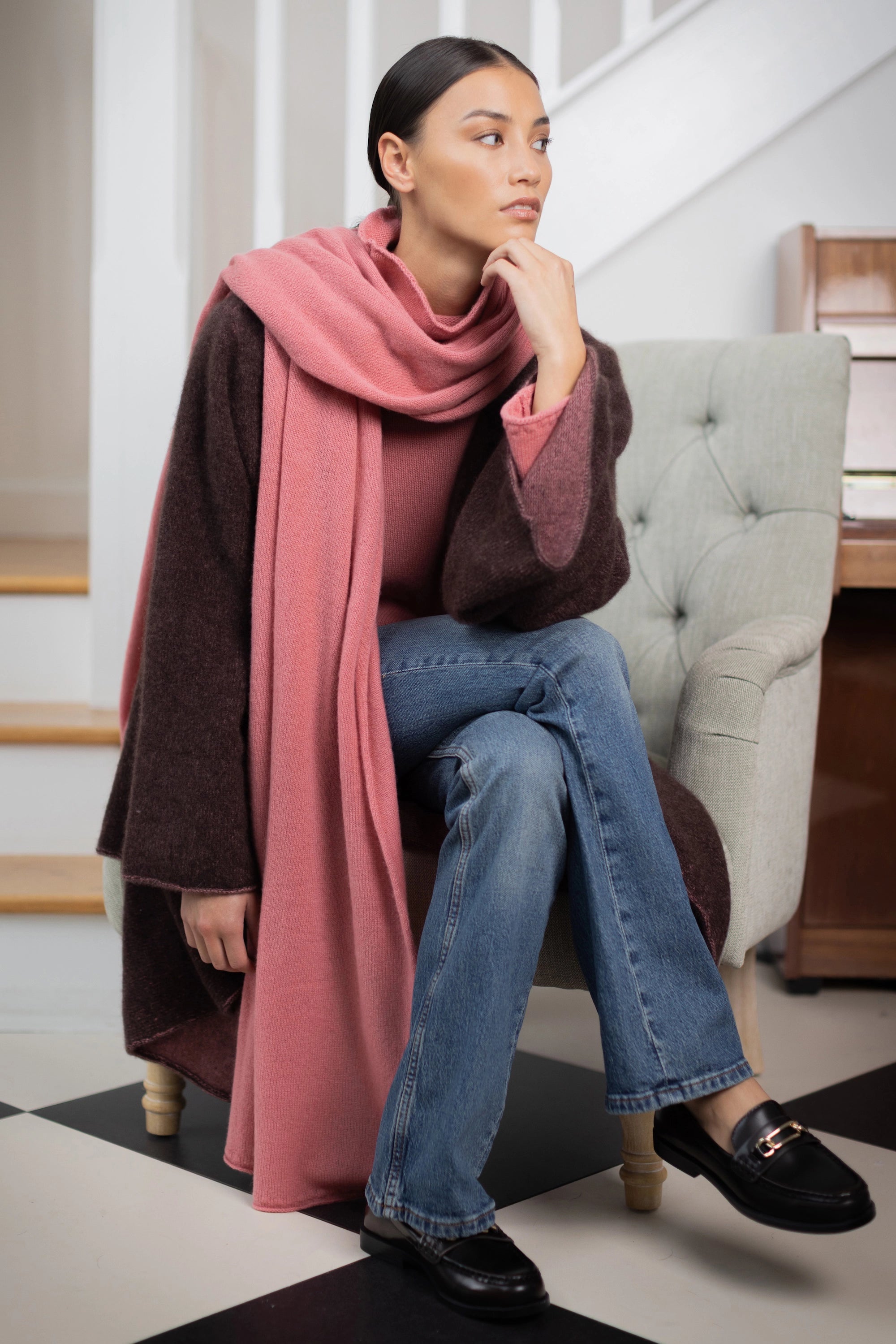 woman wearing a large cashmere travel wrap shawl in dusty pink rose 
