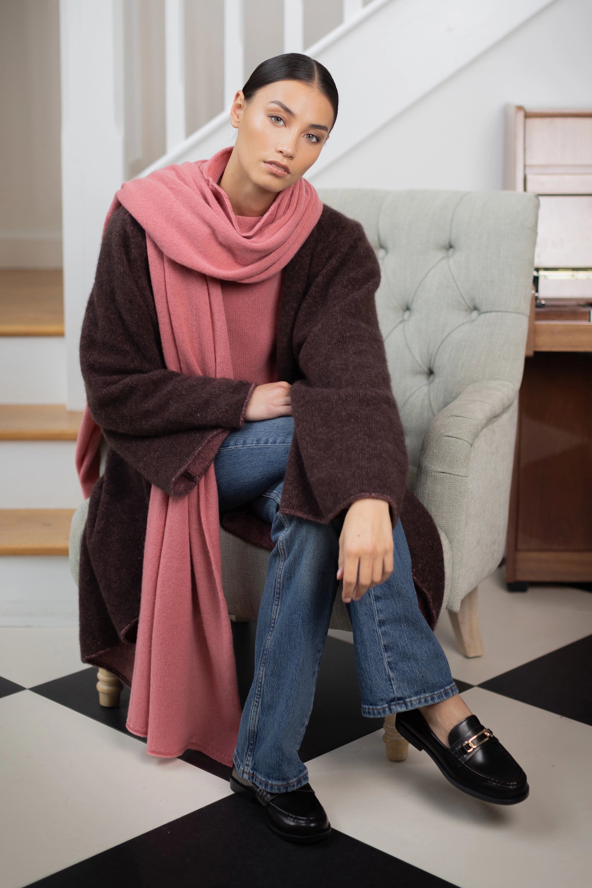 woman wearing a large cashmere travel wrap shawl in dusty pink rose 
