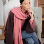 woman wearing a large cashmere travel wrap shawl in dusty pink rose 
