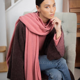 woman wearing a large cashmere travel wrap shawl in dusty pink rose 