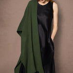 woman wearing a black dress with a large green cashmere wrap