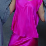 Lady wears large cashmere wrap shawl in Grey against bright pink silk top and skirt