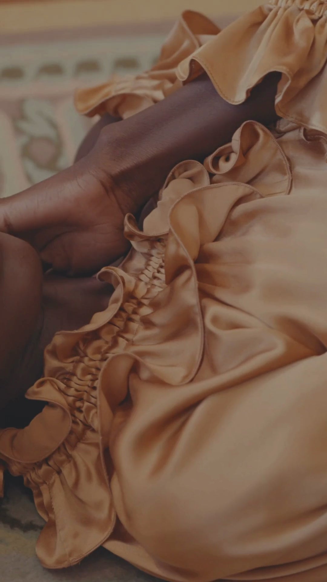 woman wearing a gold silk dress