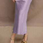 woman wearing a silk skirt in pale purple 